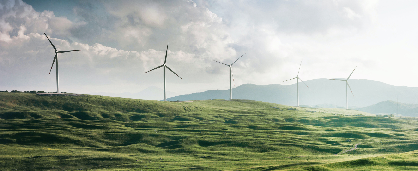 Image of turbines sitated on a green landscape
